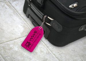 Pink neon luggage tag in use